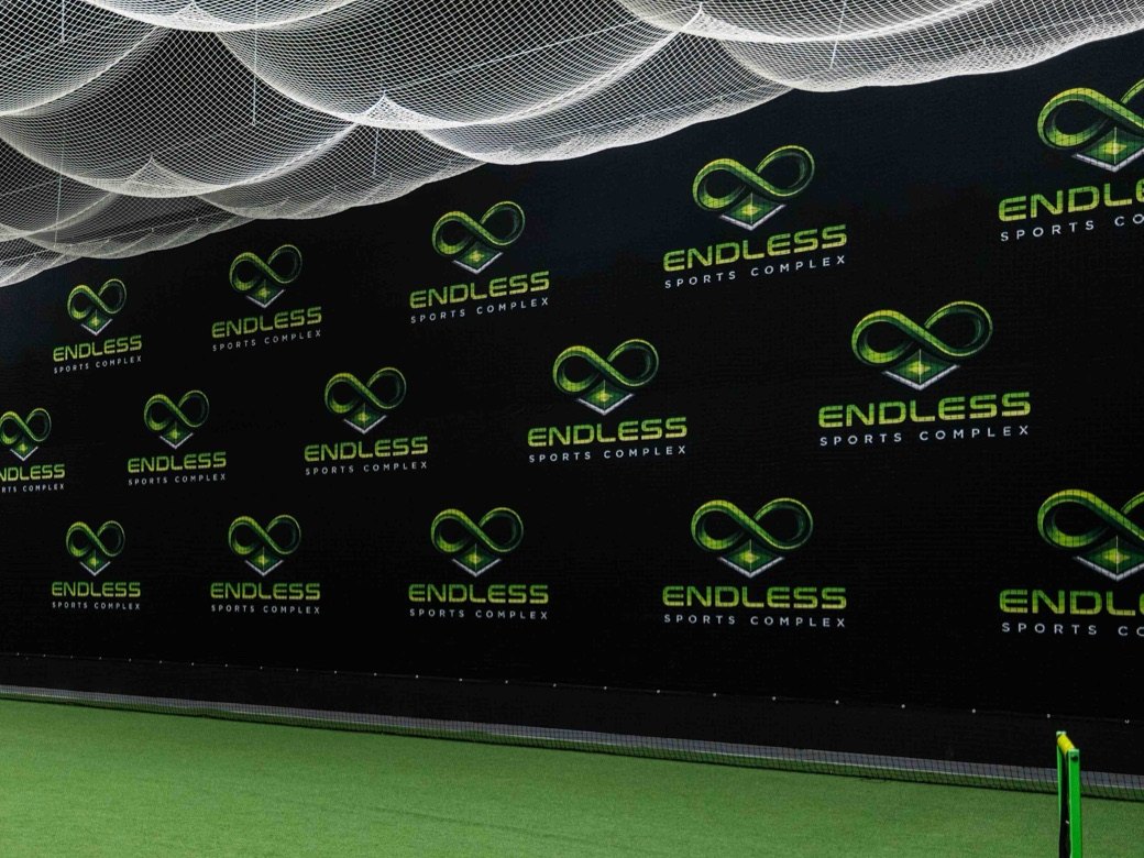 Endless Sports Complex logo wall above the indoor turf